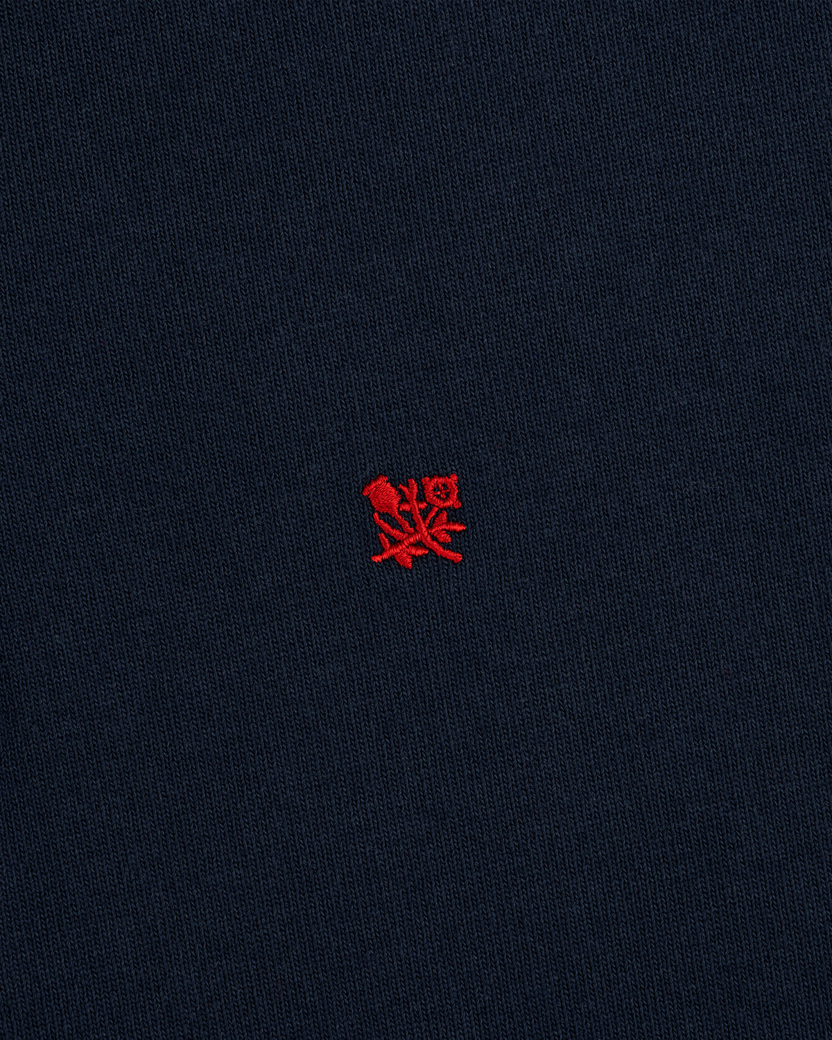 Crest Rugby: Navy blue fabric with a small red embroidered crest logo centered.