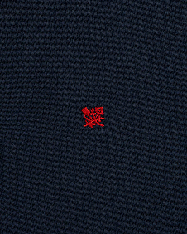 Crest Rugby: Navy blue fabric with a small red embroidered crest logo centered.