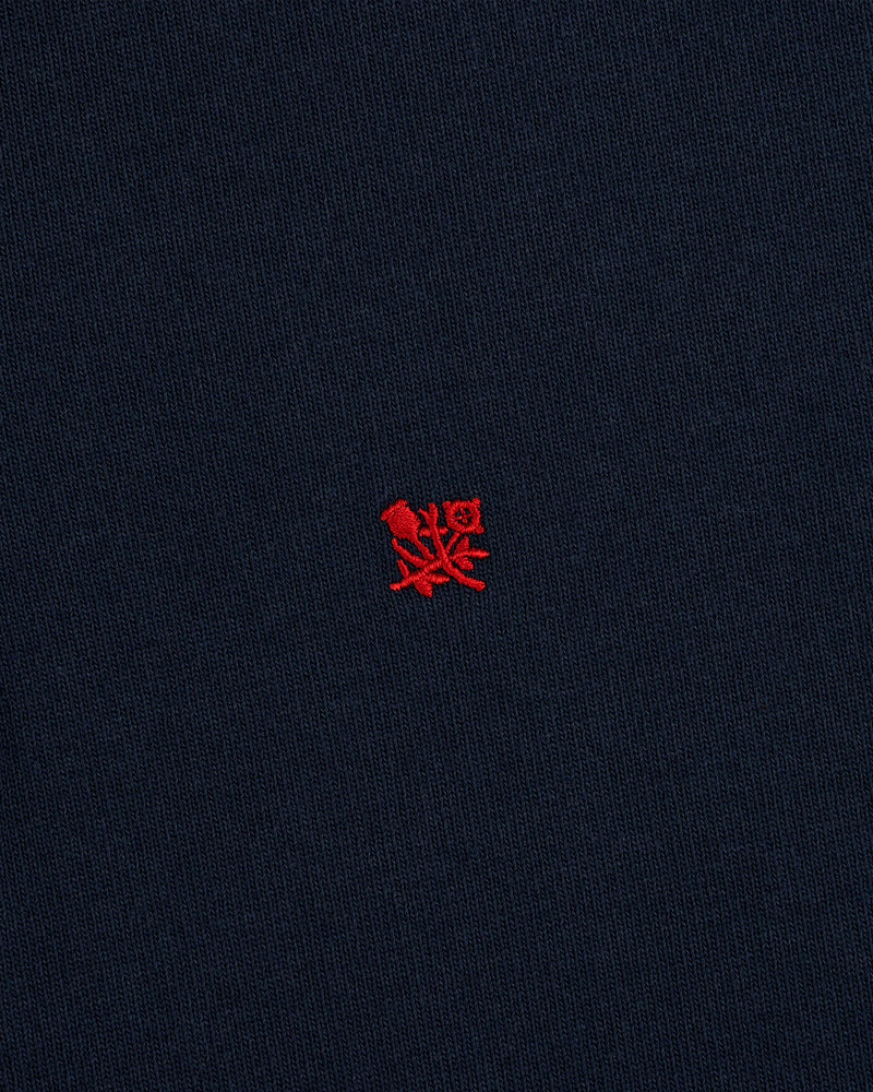 Crest Rugby: Navy blue fabric with a small red embroidered crest logo centered.