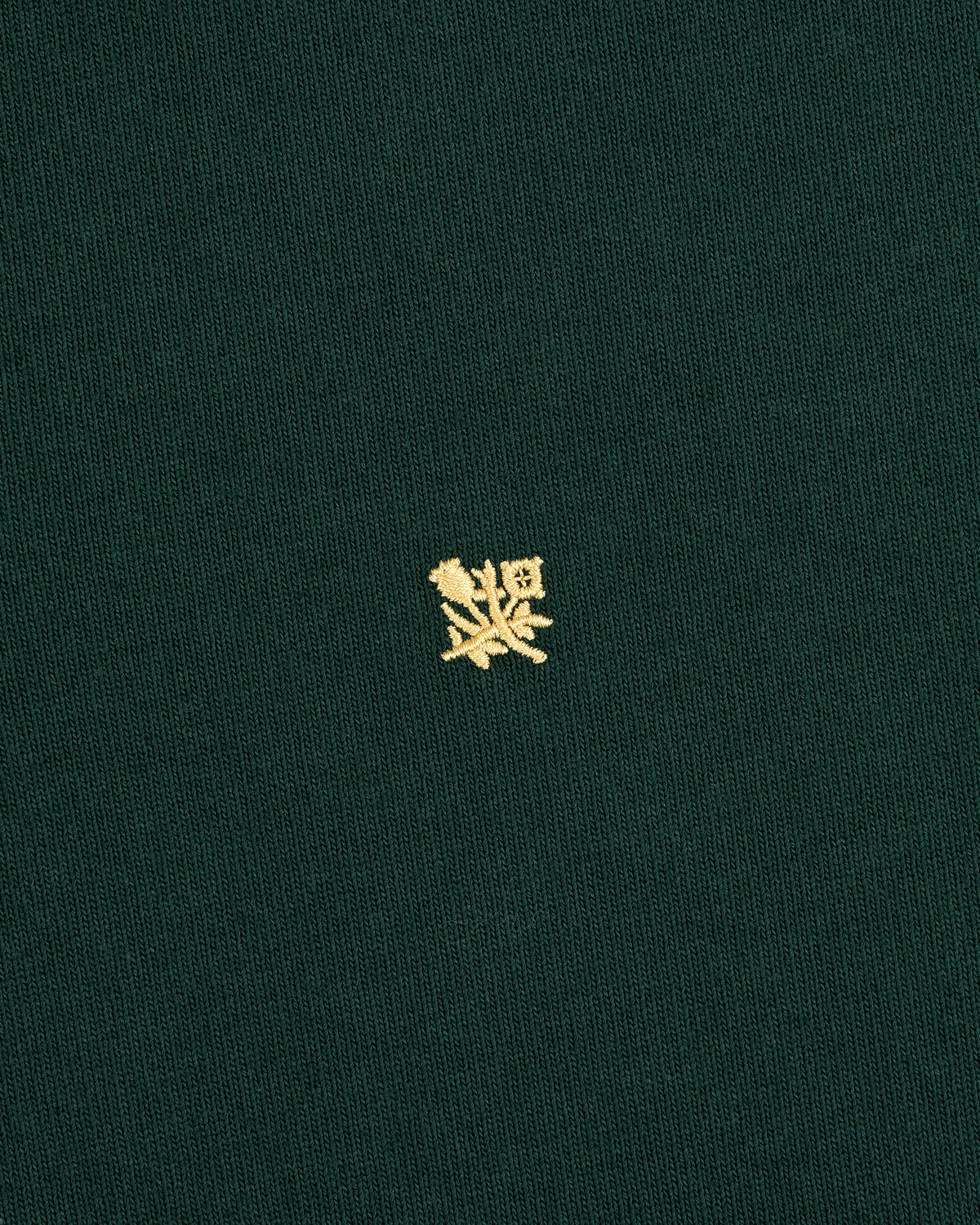 Green Crest Rugby shirt with a small yellow embroidered crest centered on the front.