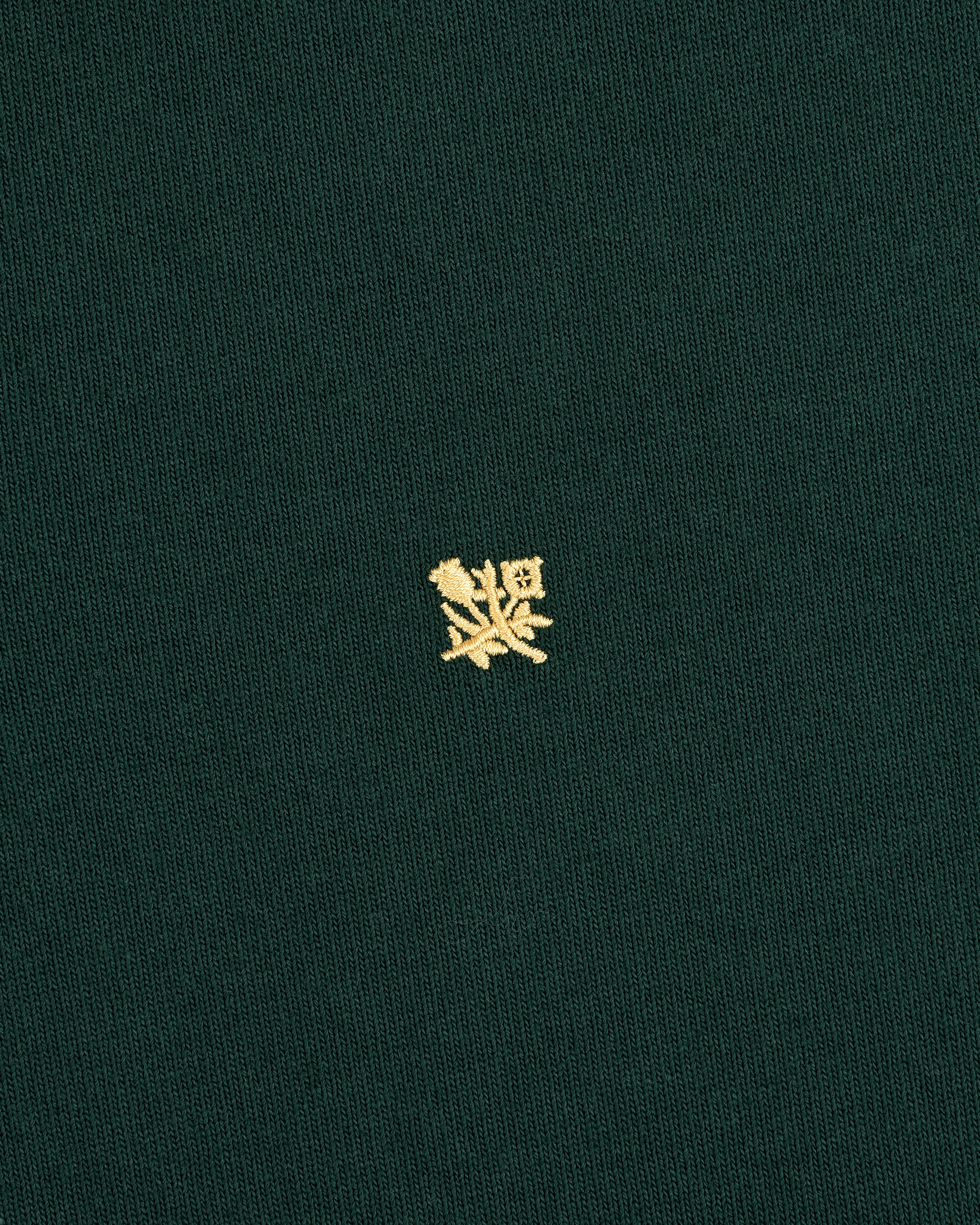 Green Crest Rugby shirt with a small yellow embroidered crest centered on the front.