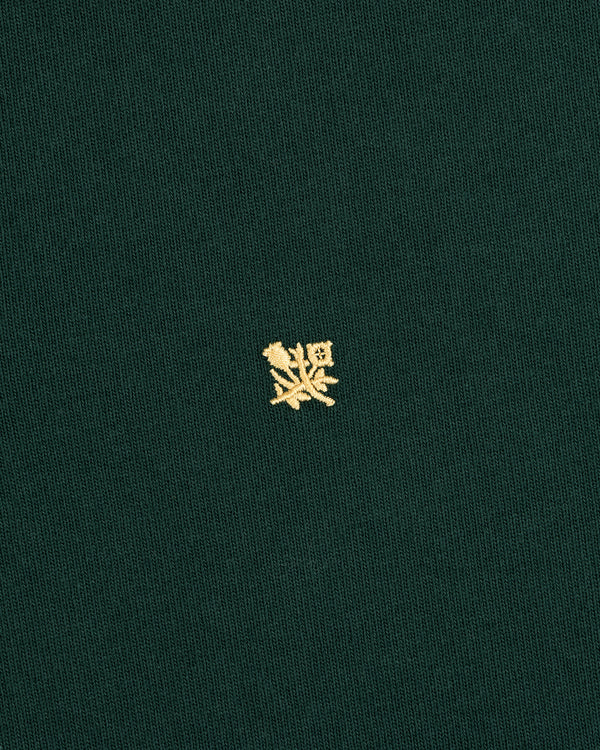 Green Crest Rugby shirt with a small yellow embroidered crest centered on the front.
