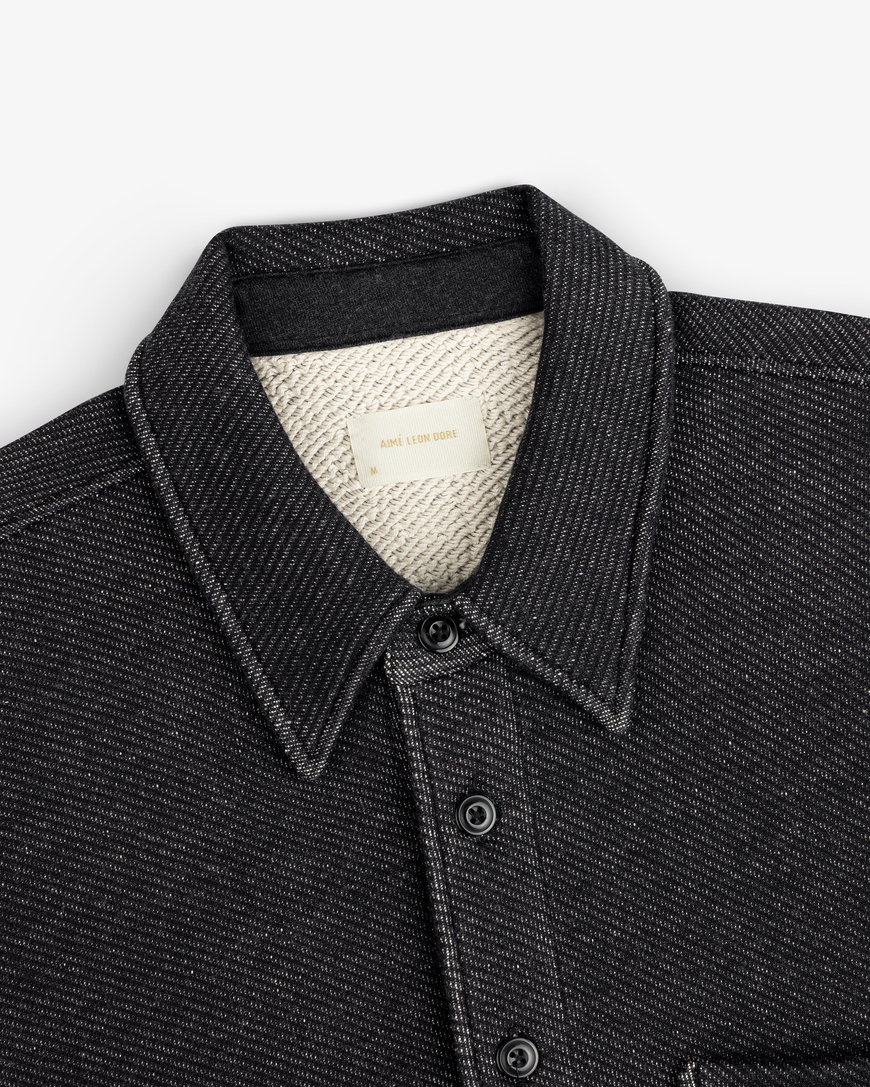 Black Terry Lounge long-sleeve shirt with a pointed collar, button front, and a textured white lining.