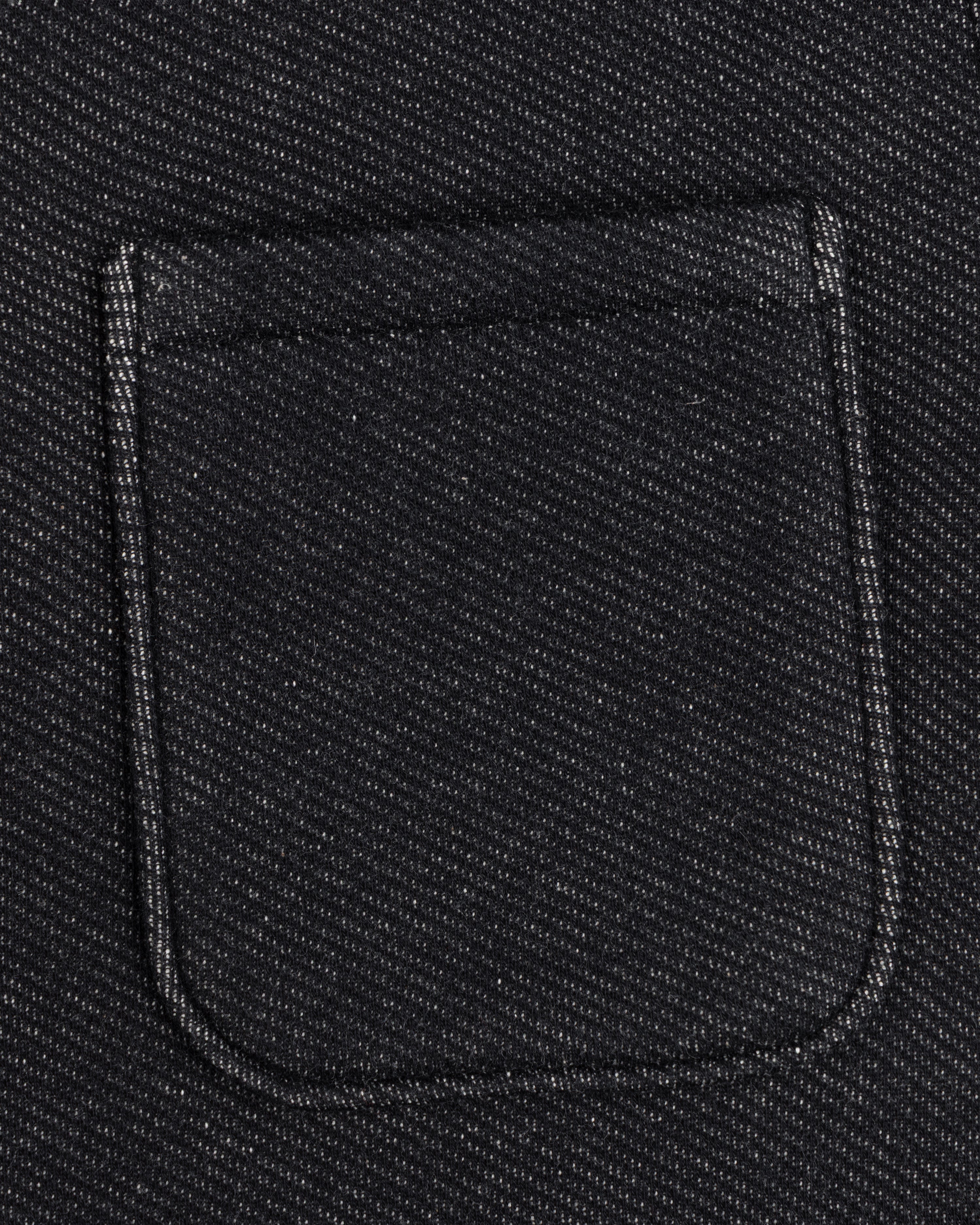 Close-up of a black textured Terry Lounge Shirt featuring a single chest pocket.