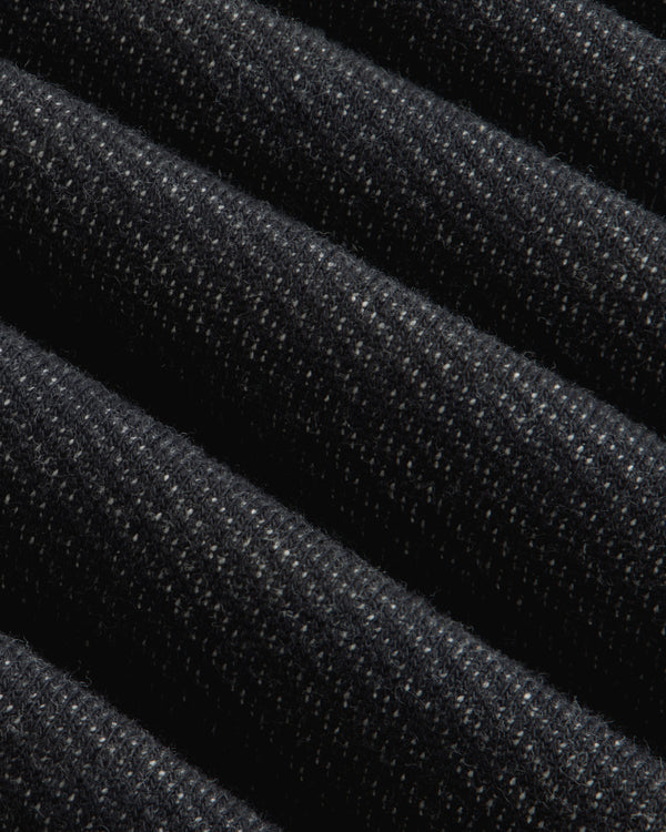 Close-up of folded dark gray Terry Lounge Shirt fabric with a textured, speckled appearance.