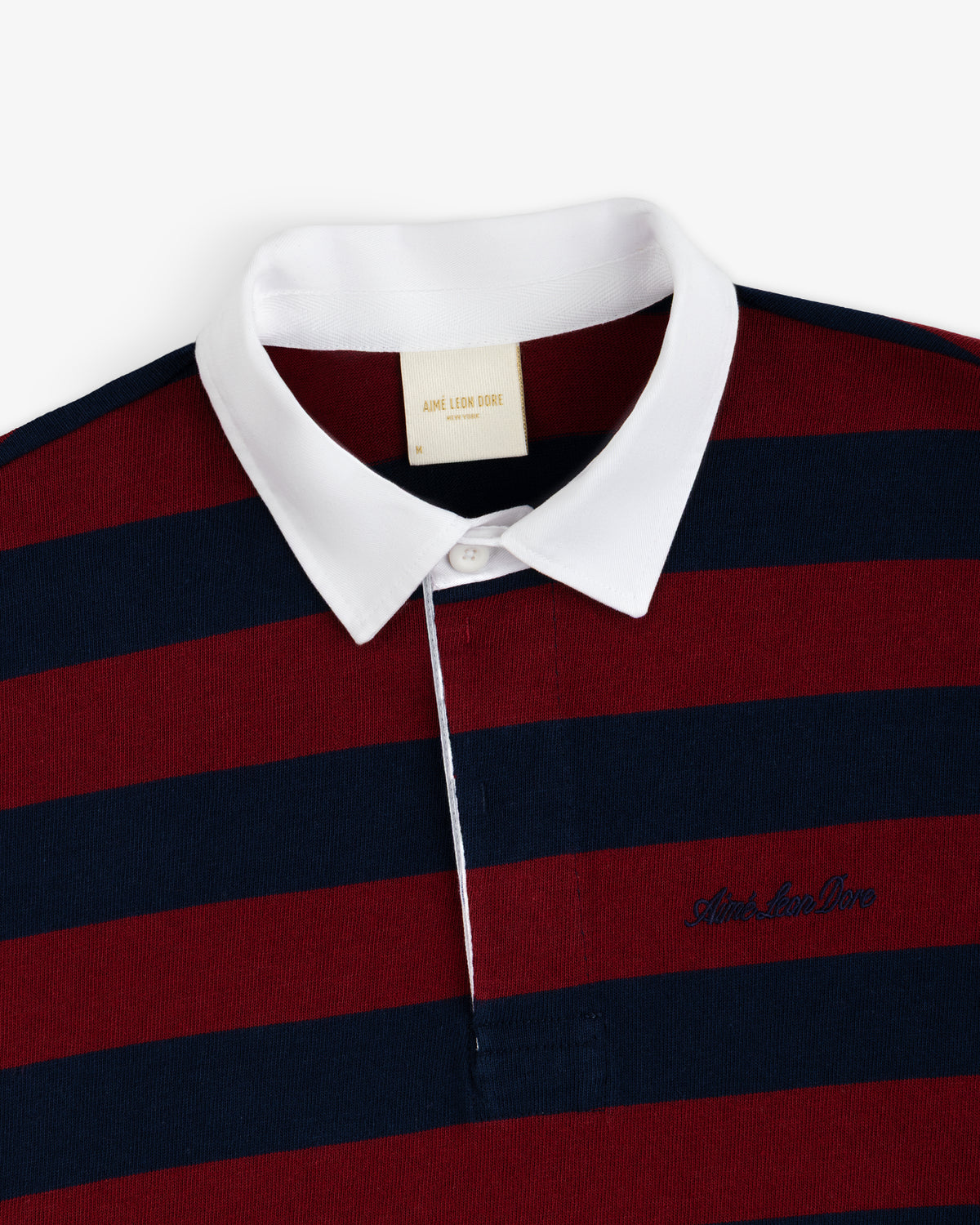 Striped Script Rugby shirt in maroon and navy stripes with a white collar and chest embroidery.
