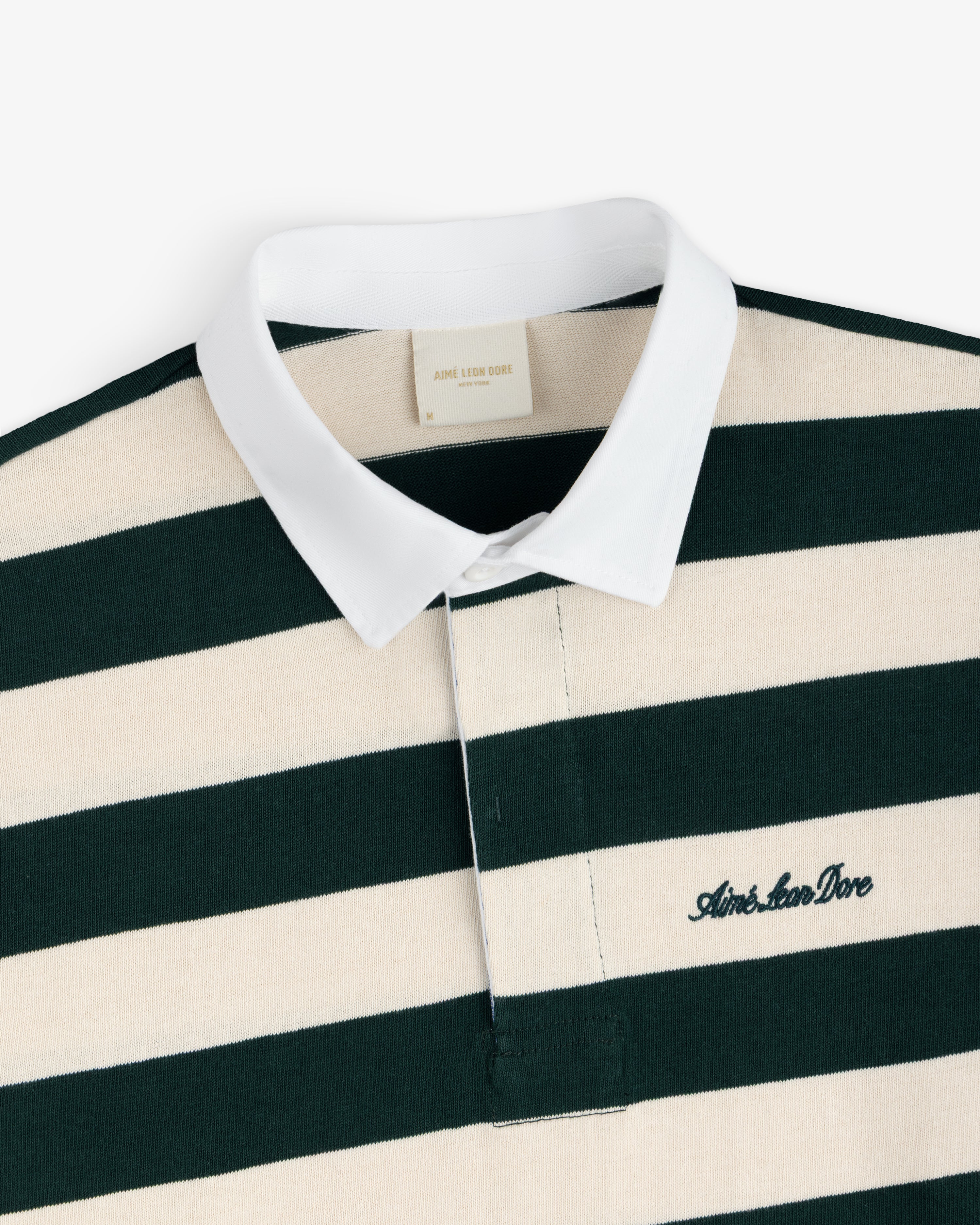 Striped Script Rugby shirt in dark green and cream with a white collar and an embroidered script logo on the chest.