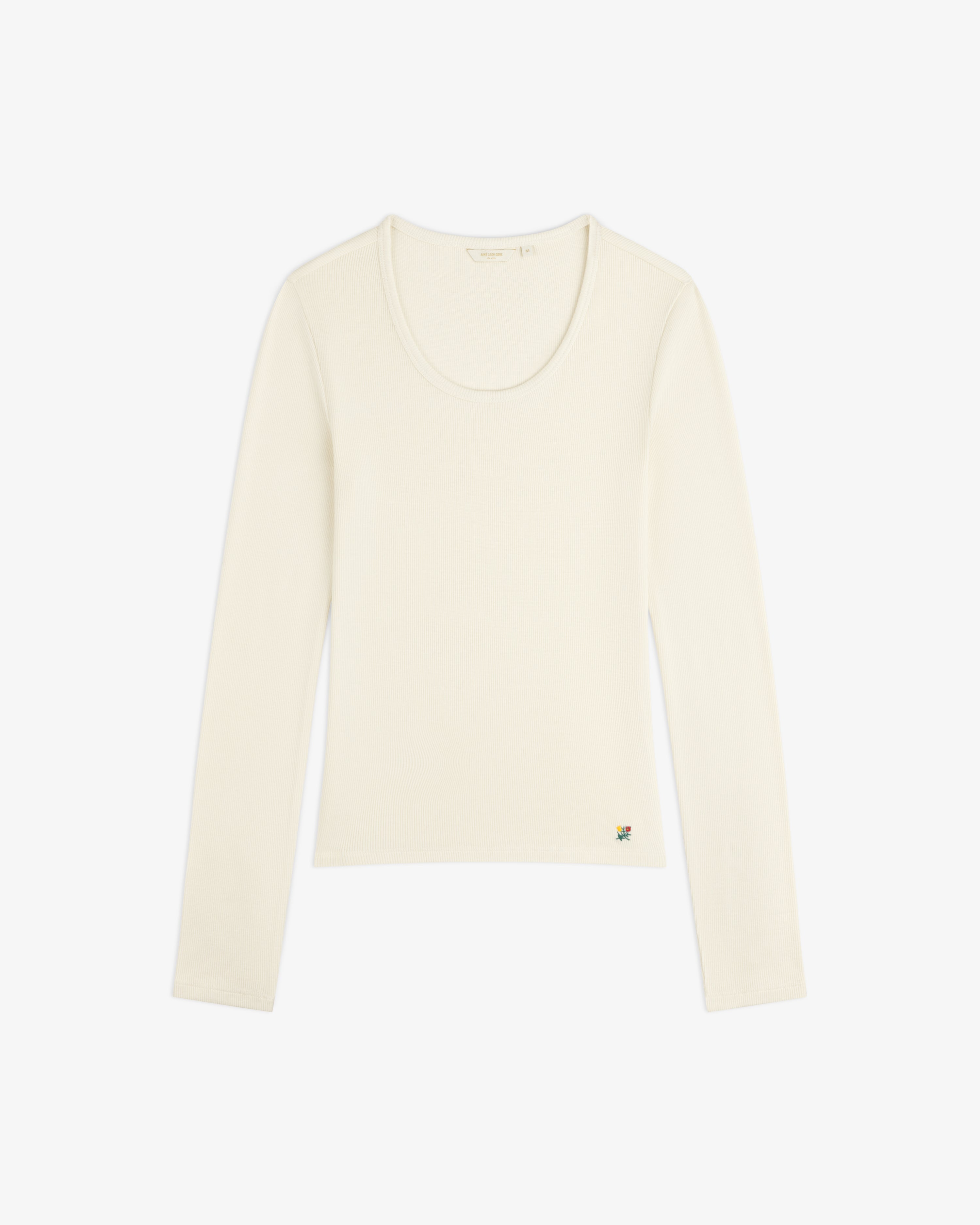 Cream-colored Ribbed Scoop Neck Long-Sleeve Tee with a small colorful embroidered detail at the hem.