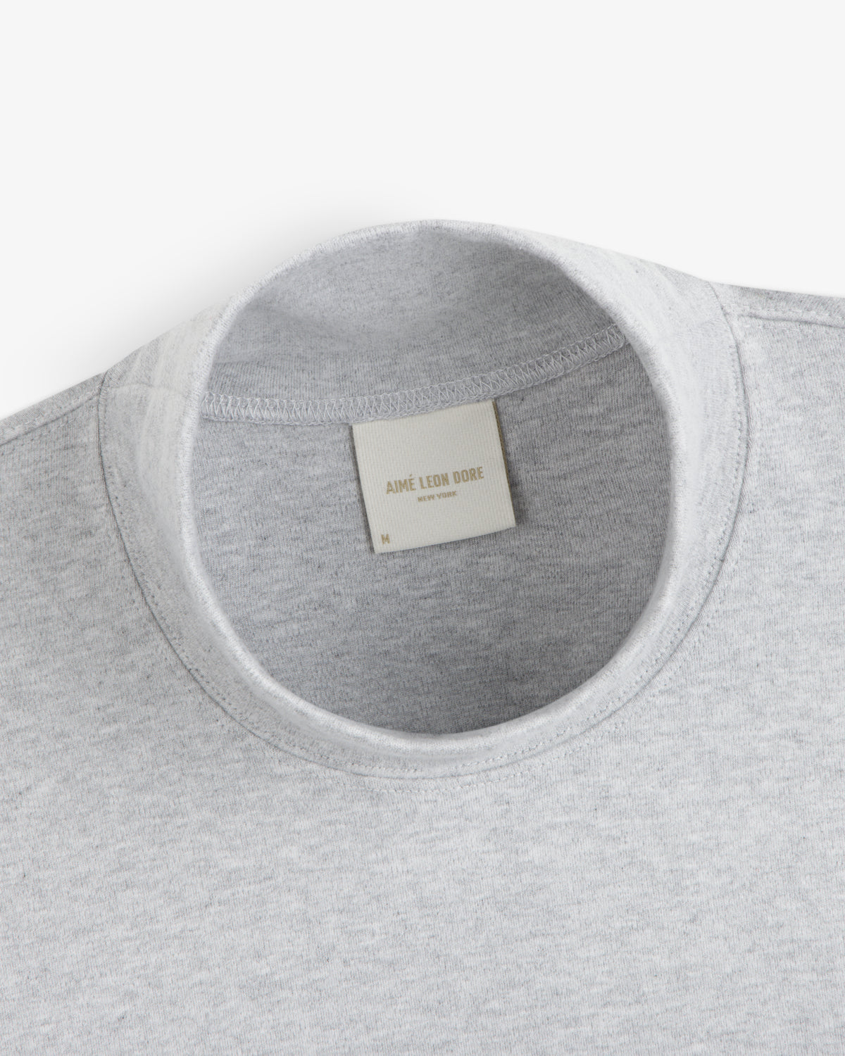 Grey Heavyweight Crest Mockneck Tee with an interior brand label at the collar.
