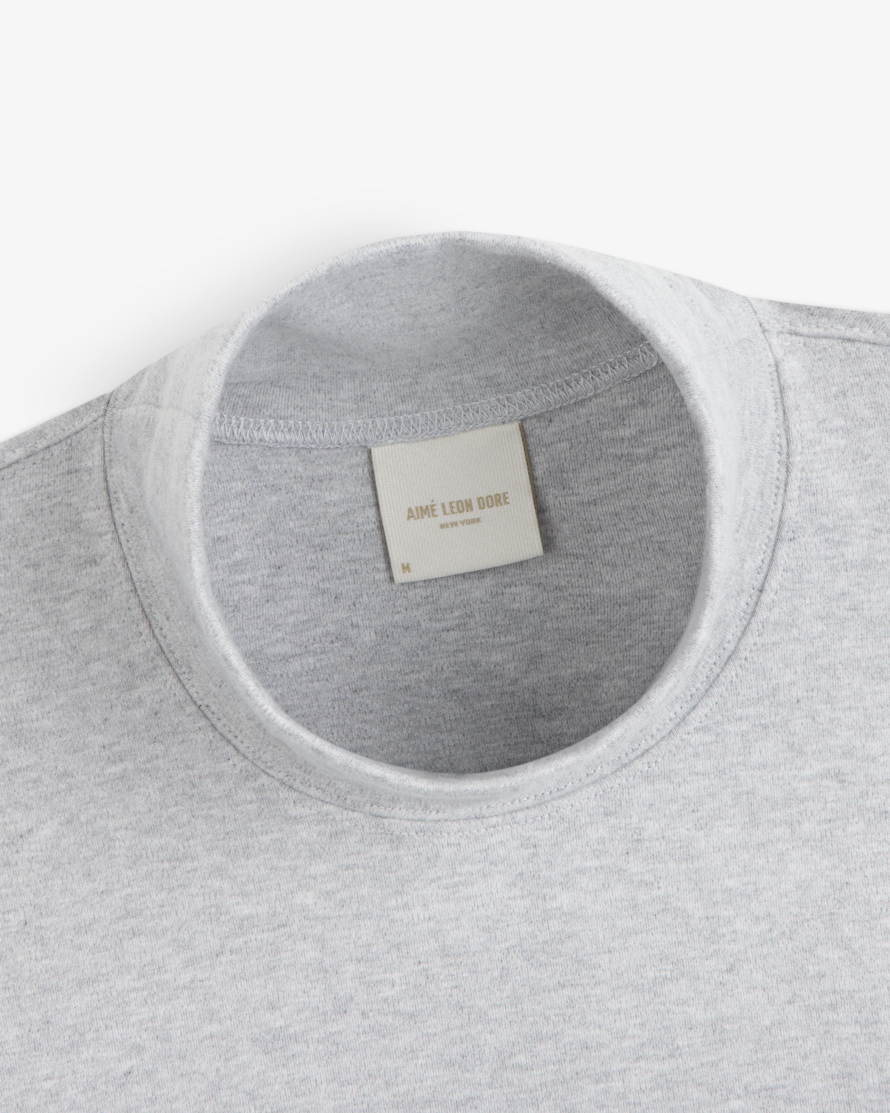 Grey Heavyweight Crest Mockneck Tee with an interior brand label at the collar.