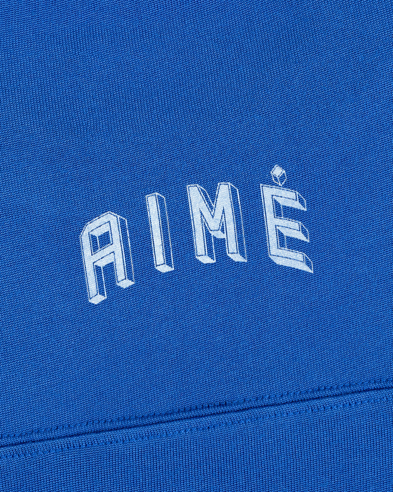 Football Ringer Tee in blue with the word AIME printed in arched, white, three-dimensional lettering.