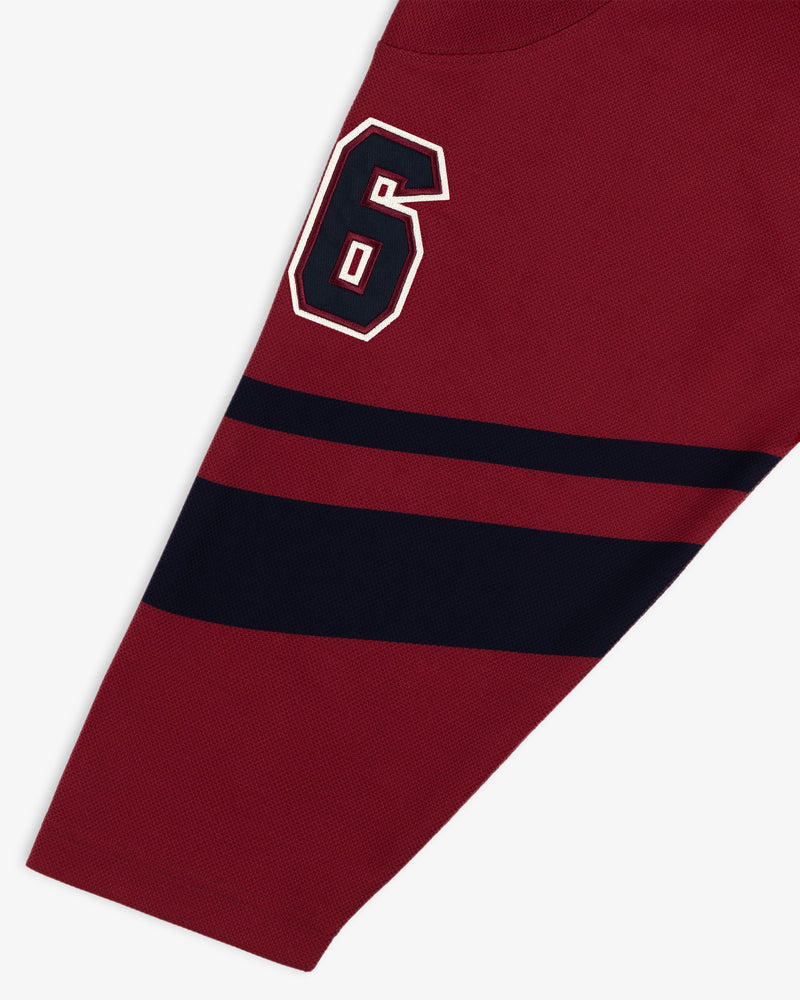 Team Aimé Hockey Jersey sleeve in maroon with a navy and white number 6 and two horizontal navy stripes.