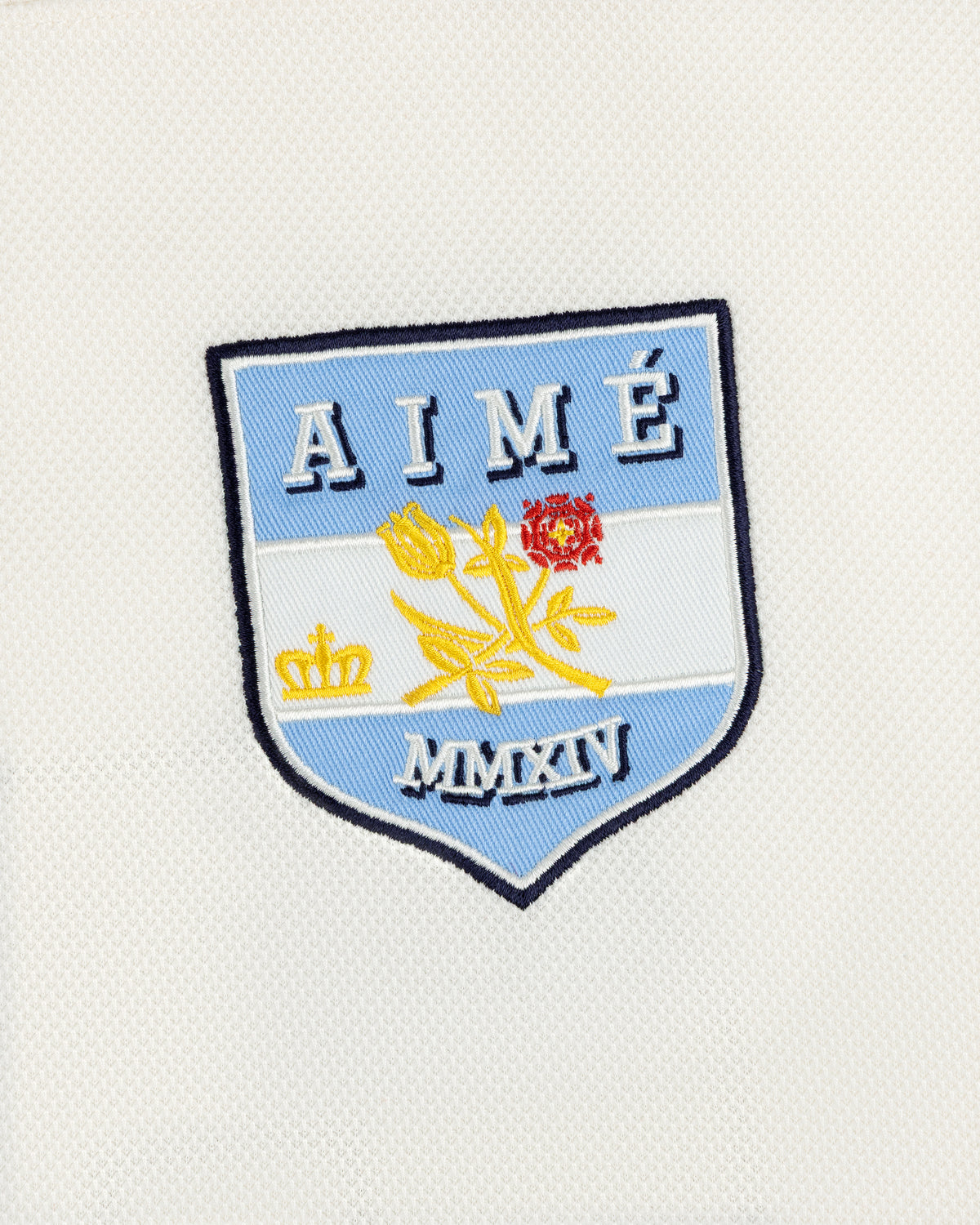 Team Aimé Hockey Jersey featuring an embroidered shield patch with a flower, crown, and the text AIMÉ and MMXIV.