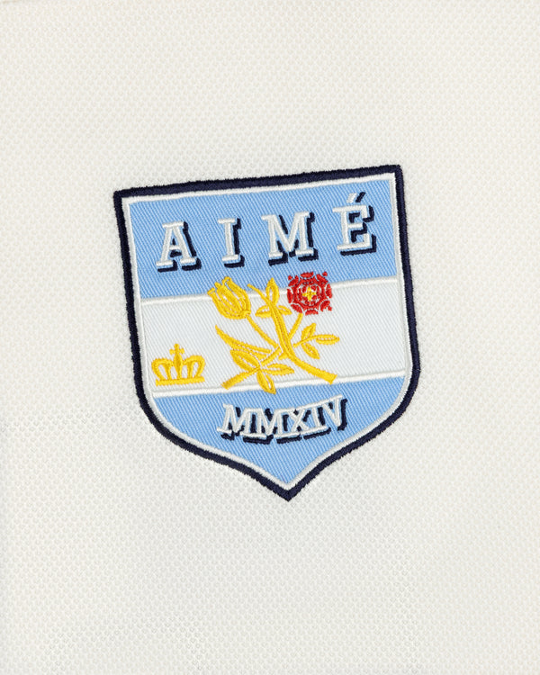 Team Aimé Hockey Jersey featuring an embroidered shield patch with a flower, crown, and the text AIMÉ and MMXIV.