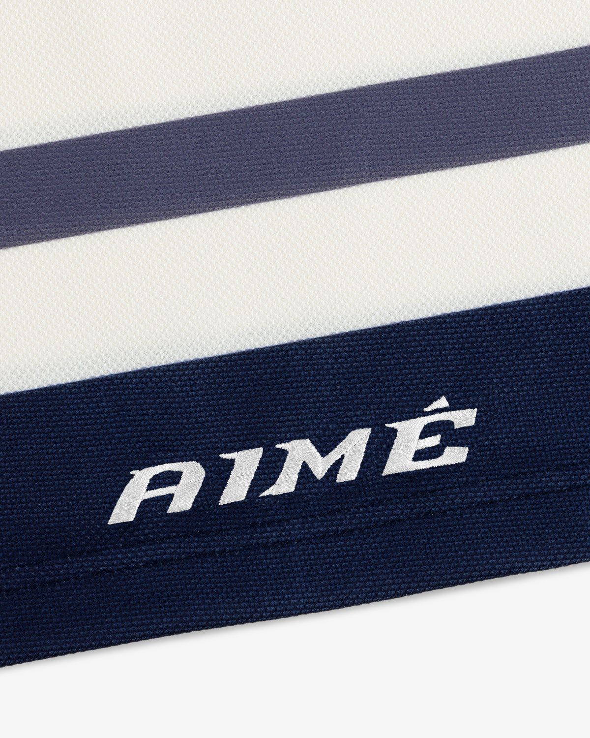 Team Aimé Hockey Jersey featuring white and navy blue stripes with the word AIMÉ embroidered on a navy stripe.