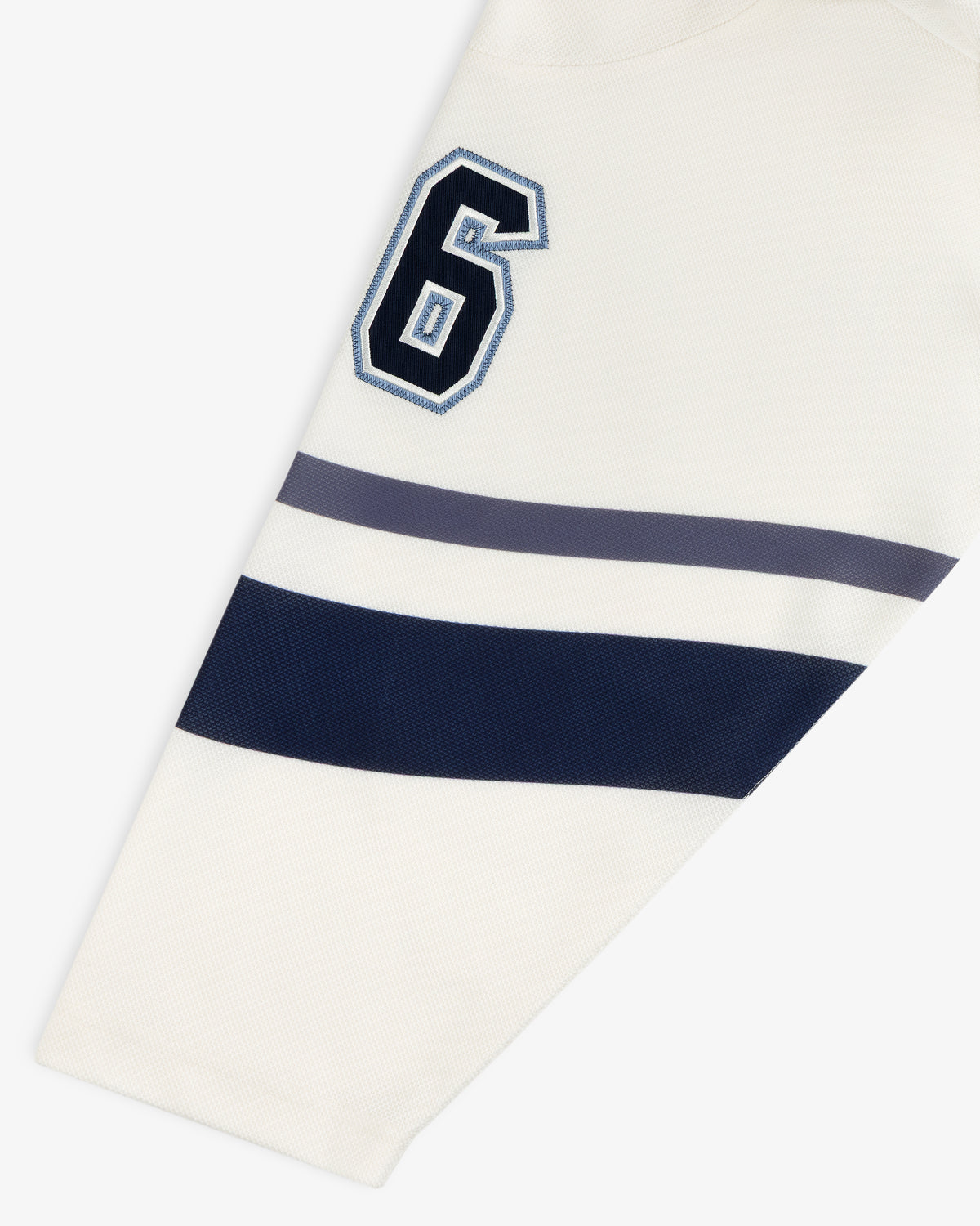 Off-white Team Aimé Hockey Jersey sleeve featuring the number 6 in navy and blue with two matching horizontal stripes.