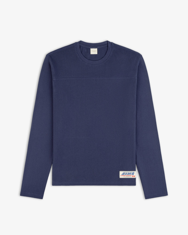 Navy Long-Sleeve Mesh Football Tee with small rectangular label on bottom right front hem.