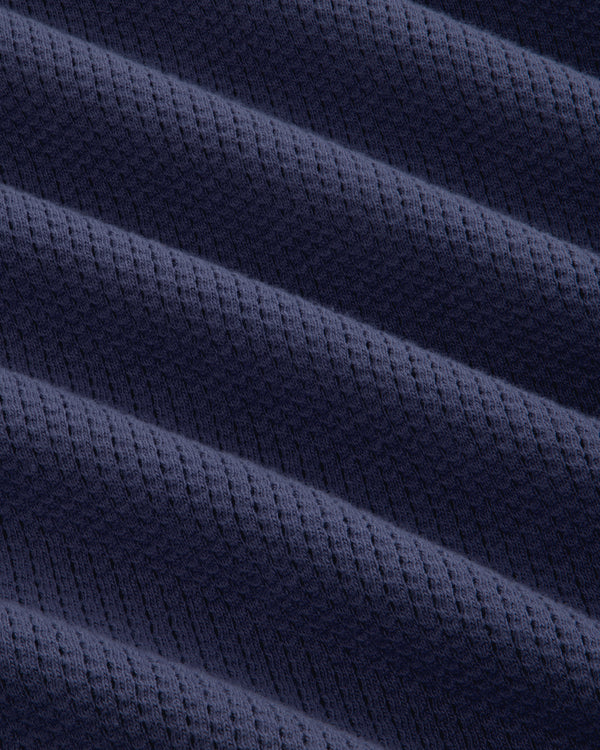 Close-up of Long-Sleeve Mesh Football Tee’s dark blue fabric, featuring diagonal ridges and a subtle waffle texture.
