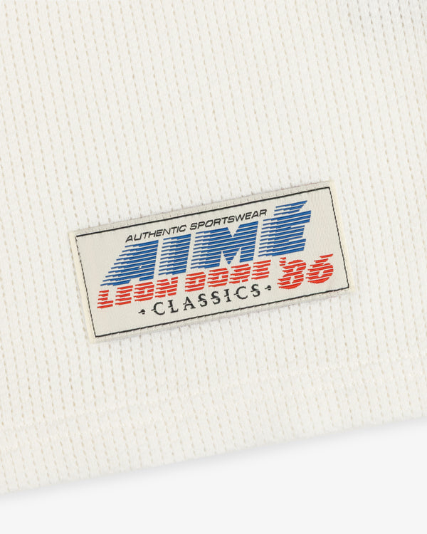 White Long-Sleeve Mesh Football Tee with ribbed fabric and sewn patch: AUTHENTIC SPORTSWEAR AMR LEON BASE 86 CLASSICS.