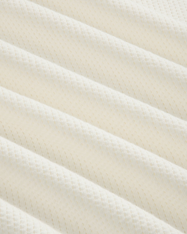 Close-up of soft, white mesh from the Long-Sleeve Mesh Football Tee, featuring ribbed texture and subtle patterns.