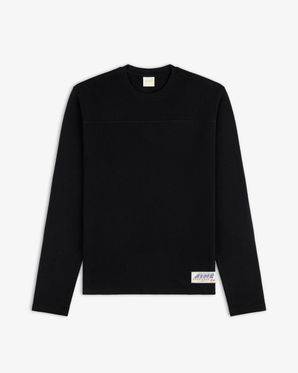 Long-Sleeve Mesh Football Tee in black with a small patch by the hem, displayed on a white background.