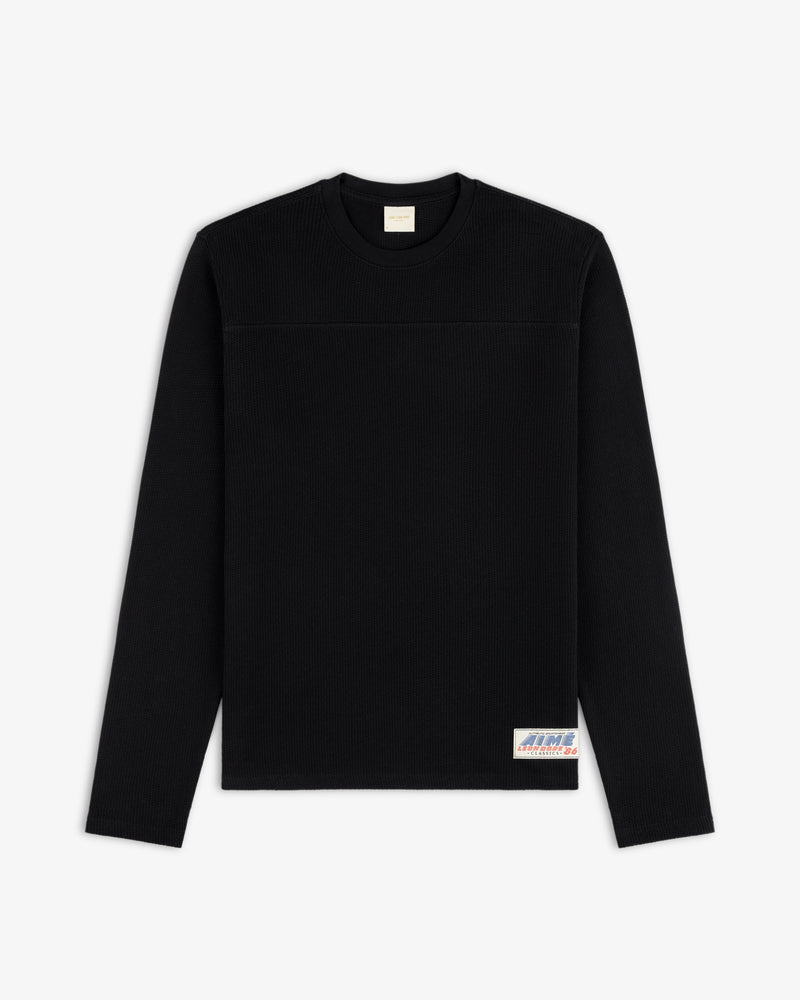 Long-Sleeve Mesh Football Tee in black with a small patch by the hem, displayed on a white background.