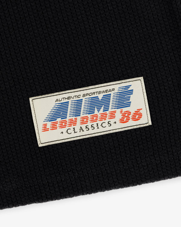 A white & blue patch on black mesh reads: AUTHENTIC SPORTSWEAR ATMOS CLASSICS LEON BASE 36 Football Tee.