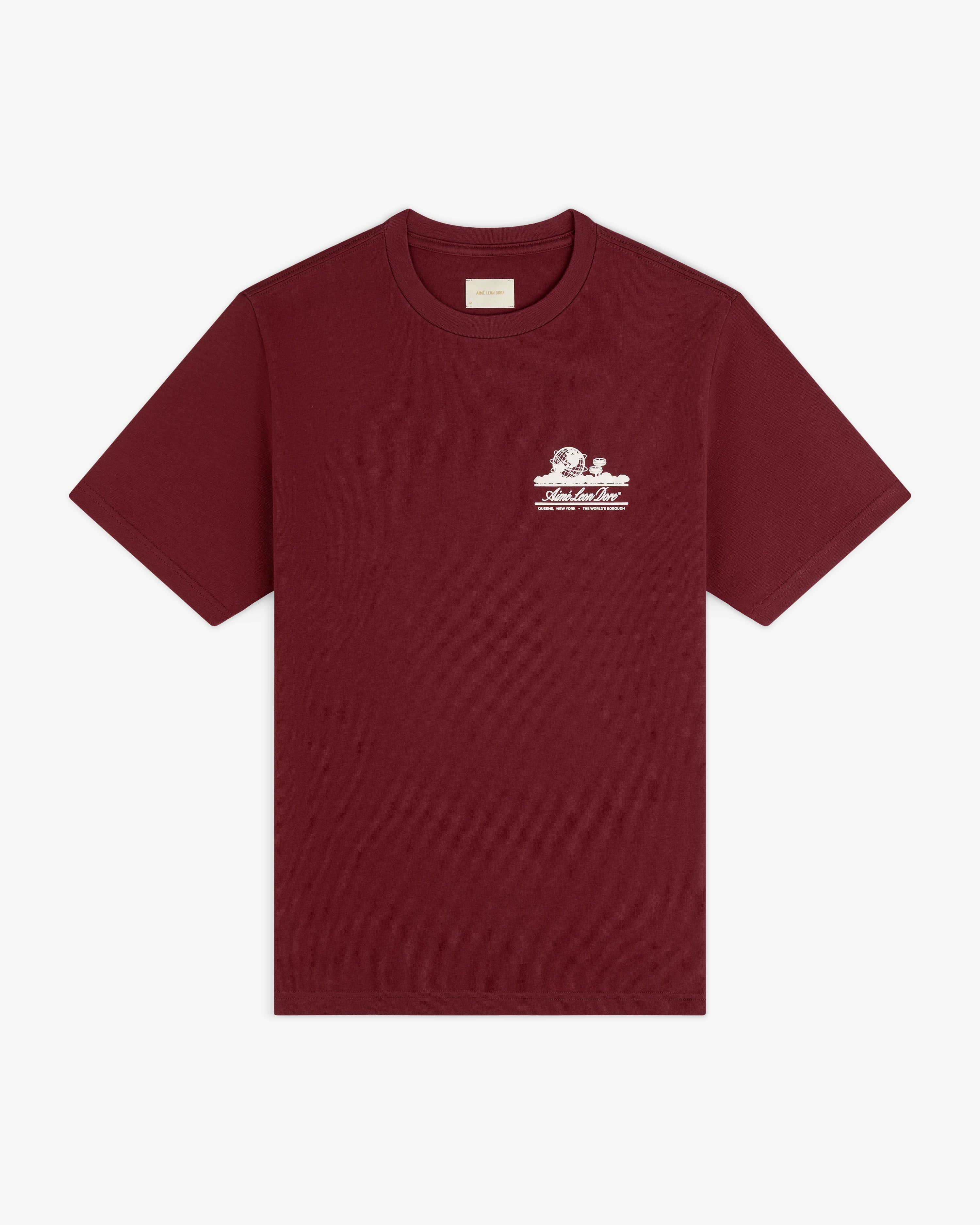 Unisphere Tee in burgundy with a small white graphic and text on the left chest, shown on a white background.