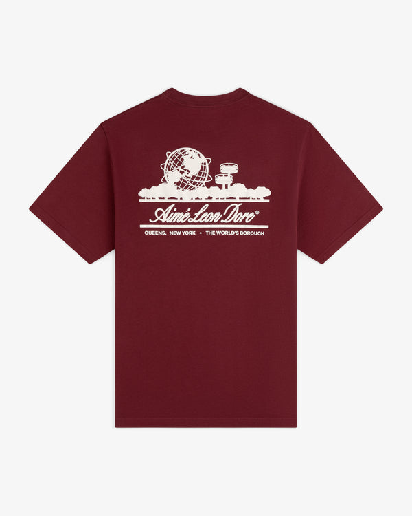 Maroon Unisphere Tee with white globe, clouds, and “Queens, New York - The World’s Borough” graphic.