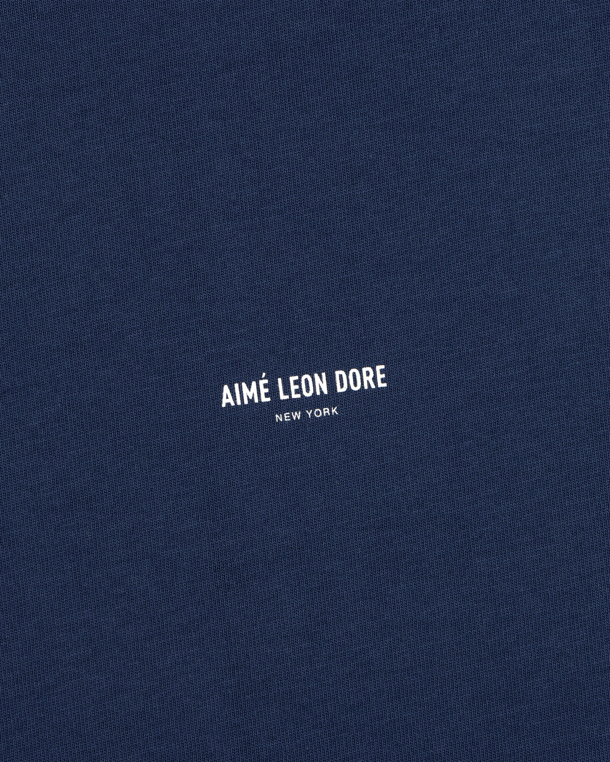 Navy blue Micro Logo Tee with small white AIMÉ LEON DORE NEW YORK print at the center.