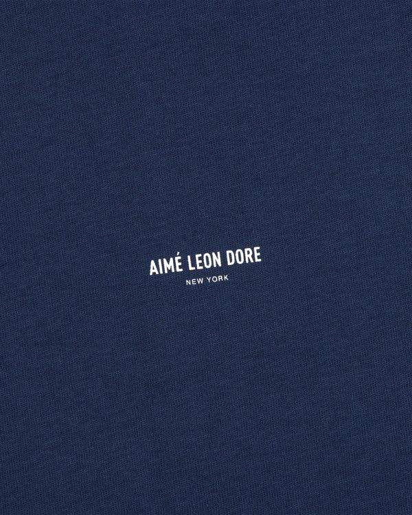 Navy blue Micro Logo Tee with small white AIMÉ LEON DORE NEW YORK print at the center.