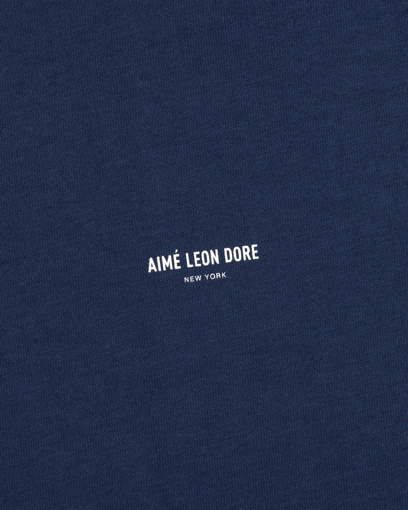 Navy blue Micro Logo Tee with small white AIMÉ LEON DORE NEW YORK print at the center.