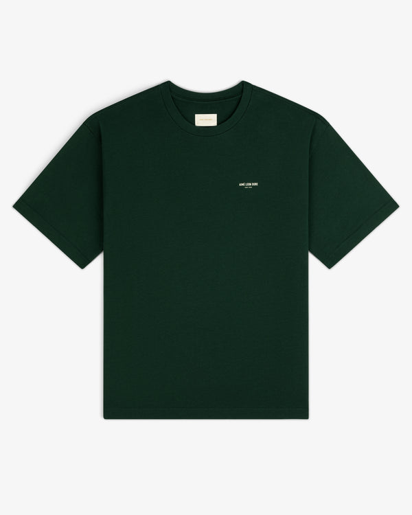 Micro Logo Tee in dark green with a small white chest label, shown on a white background.