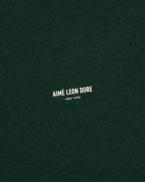 Dark green Micro Logo Tee with small white AIMÉ LEON DORE NEW YORK text centered on the front.