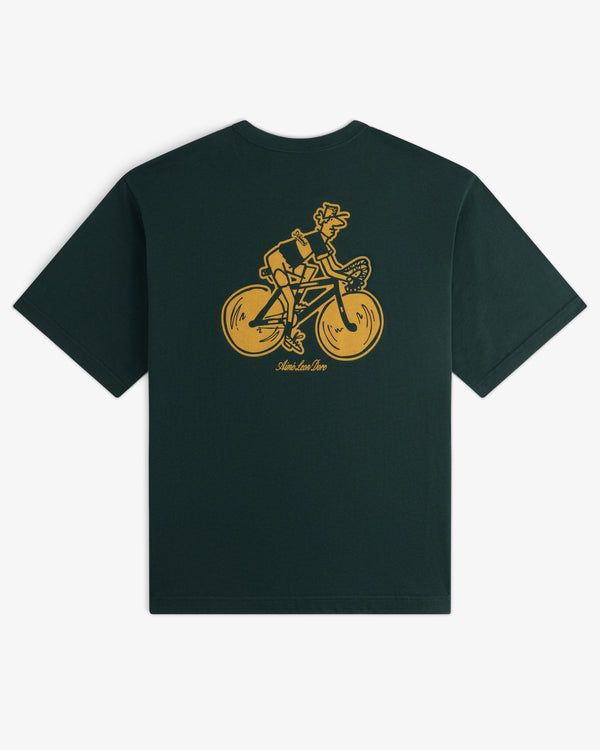 Aimé Tour Graphic Tee in dark green with a yellow cartoon dog on a bicycle and text below, graphic on the back.