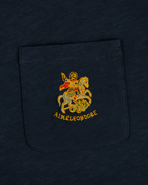 Navy Saint George Slub Pocket Tee with embroidered horseback figure, red cape, dragon, and AIME LEON DORE text.