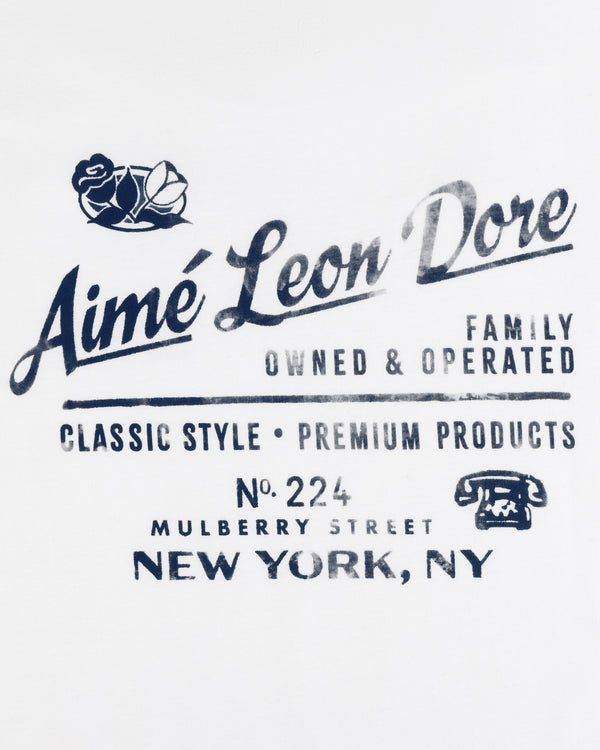 Neighborhood Tee: Navy Aimé Leon Dore logo, roses, vintage phone graphic on white background.