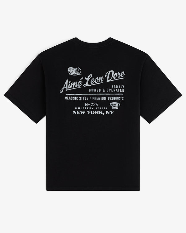 Neighborhood Tee: Black T-shirt with white Aime Leon Dore and New York, NY graphics on the back.