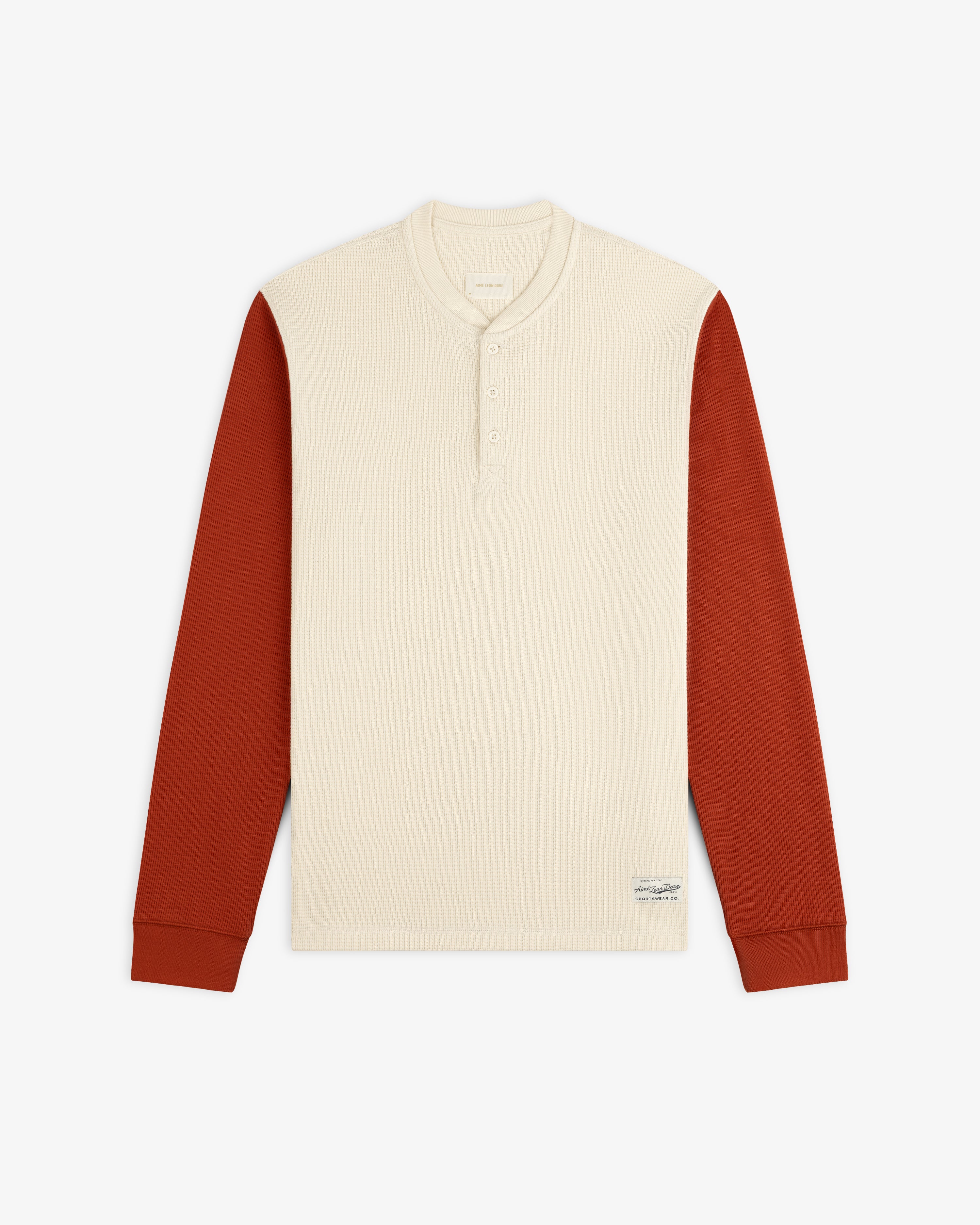 Cream-colored Long-Sleeve Waffle Henley with rust-colored sleeves.
