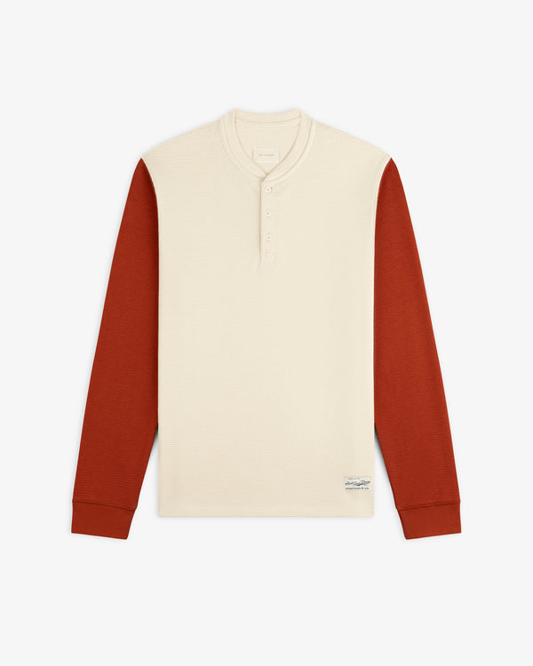Cream-colored Long-Sleeve Waffle Henley with rust-colored sleeves.
