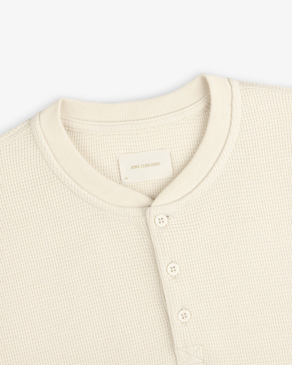 Cream-colored Long-Sleeve Waffle Henley shirt with a waffle-knit texture and a button placket.