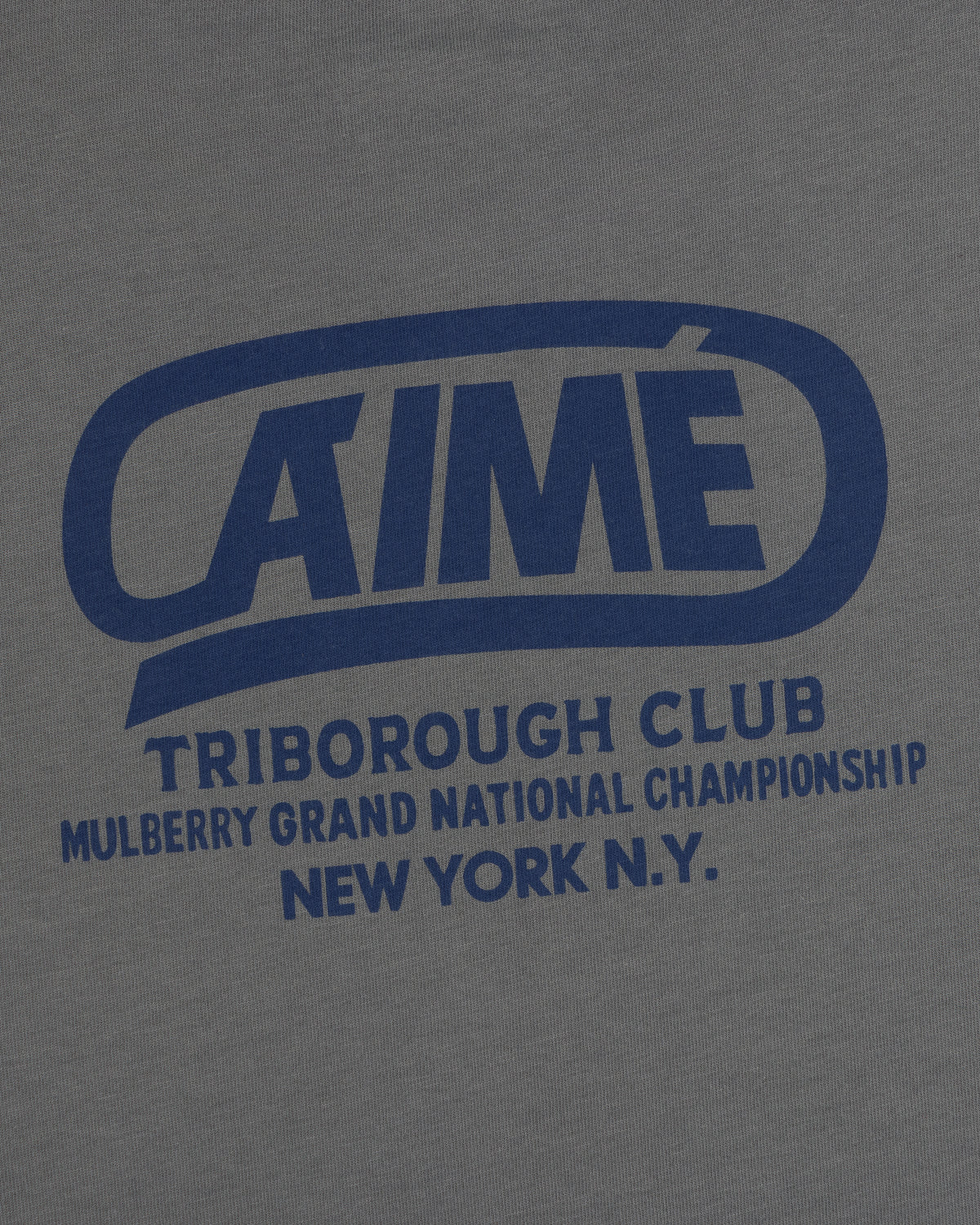Dark grey Triborough Club Tee with blue text reading AIME TRIBOROUGH CLUB MULBERRY GRAND NATIONAL CHAMPIONSHIP NEW YORK N.Y.