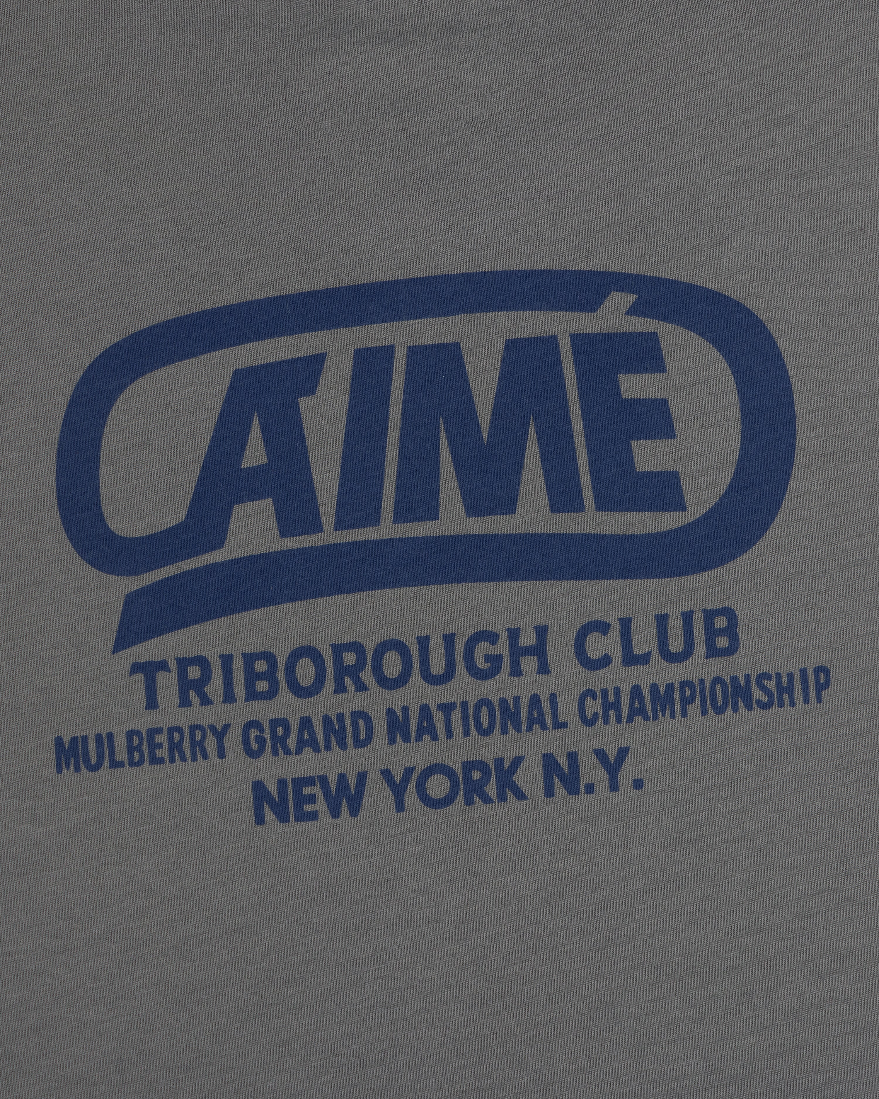 Dark grey Triborough Club Tee with blue text reading AIME TRIBOROUGH CLUB MULBERRY GRAND NATIONAL CHAMPIONSHIP NEW YORK N.Y.