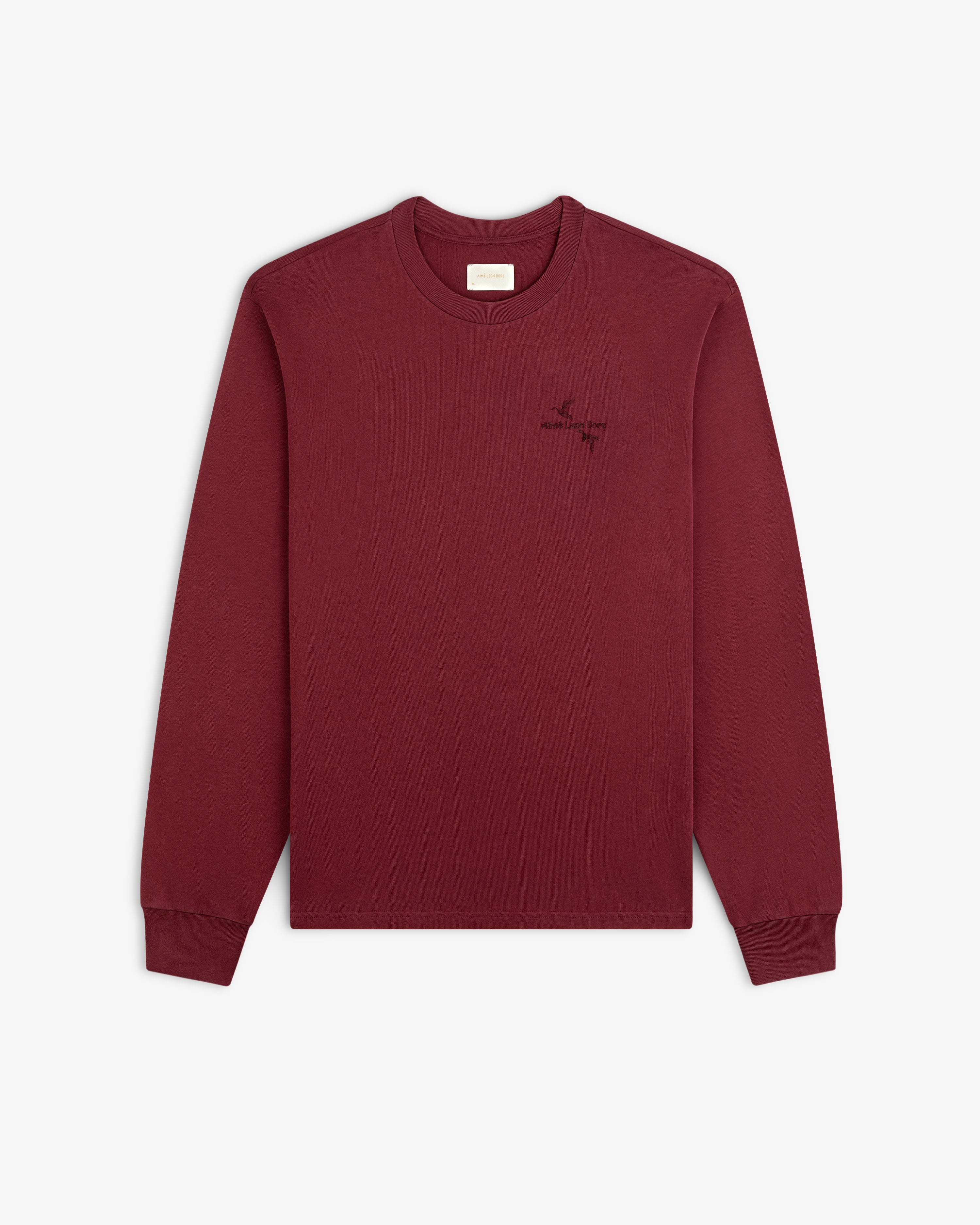 Maroon Long-Sleeve Retriever Tee with a small embroidered bird and text logo on the left chest.