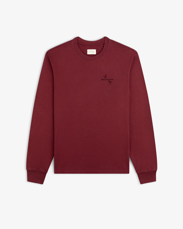 Maroon Long-Sleeve Retriever Tee with a small embroidered bird and text logo on the left chest.
