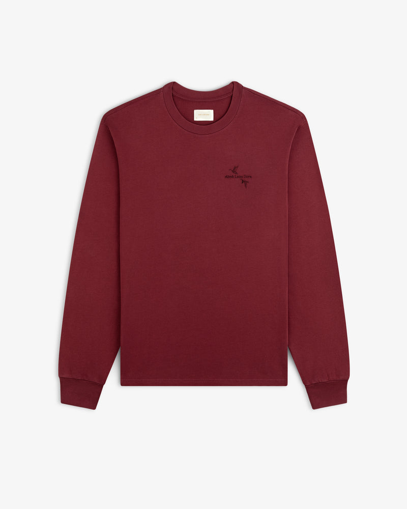 Maroon Long-Sleeve Retriever Tee with a small embroidered bird and text logo on the left chest.