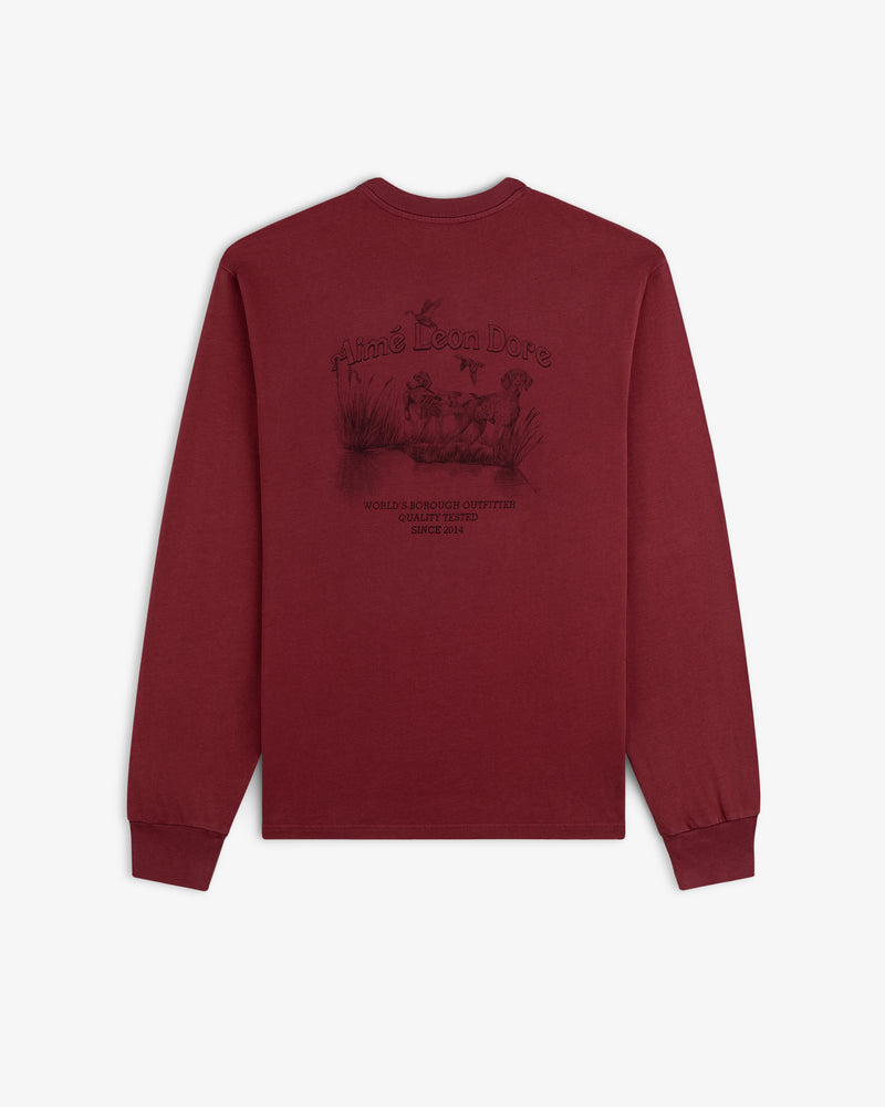 Maroon Long-Sleeve Retriever Tee featuring a back graphic of a dog in a marsh with text.