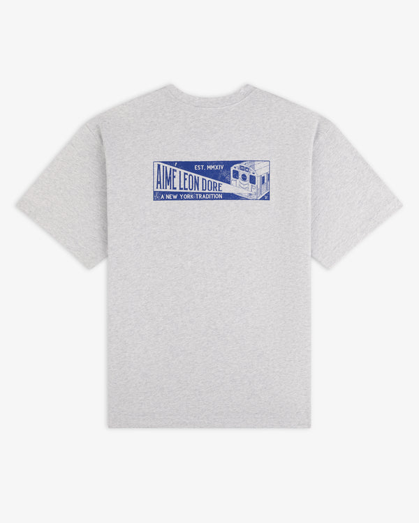 Gray short-sleeve Aimé Transit Tee with a blue graphic on the back featuring a subway car and text.