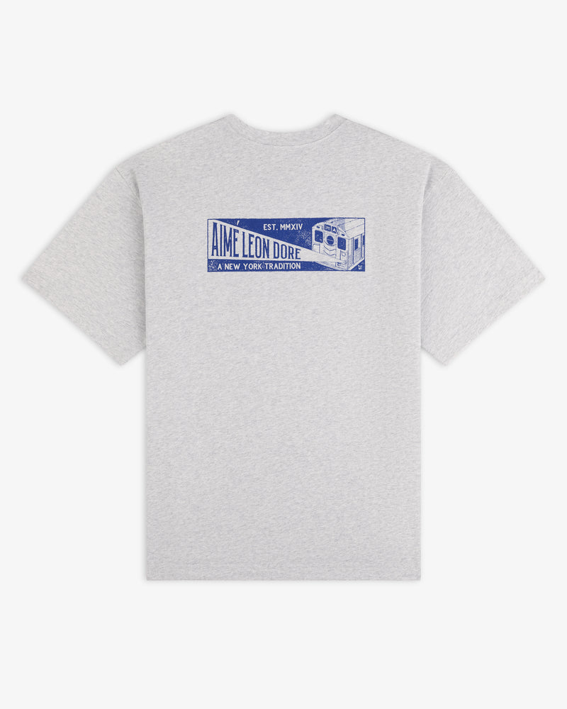 Gray short-sleeve Aimé Transit Tee with a blue graphic on the back featuring a subway car and text.