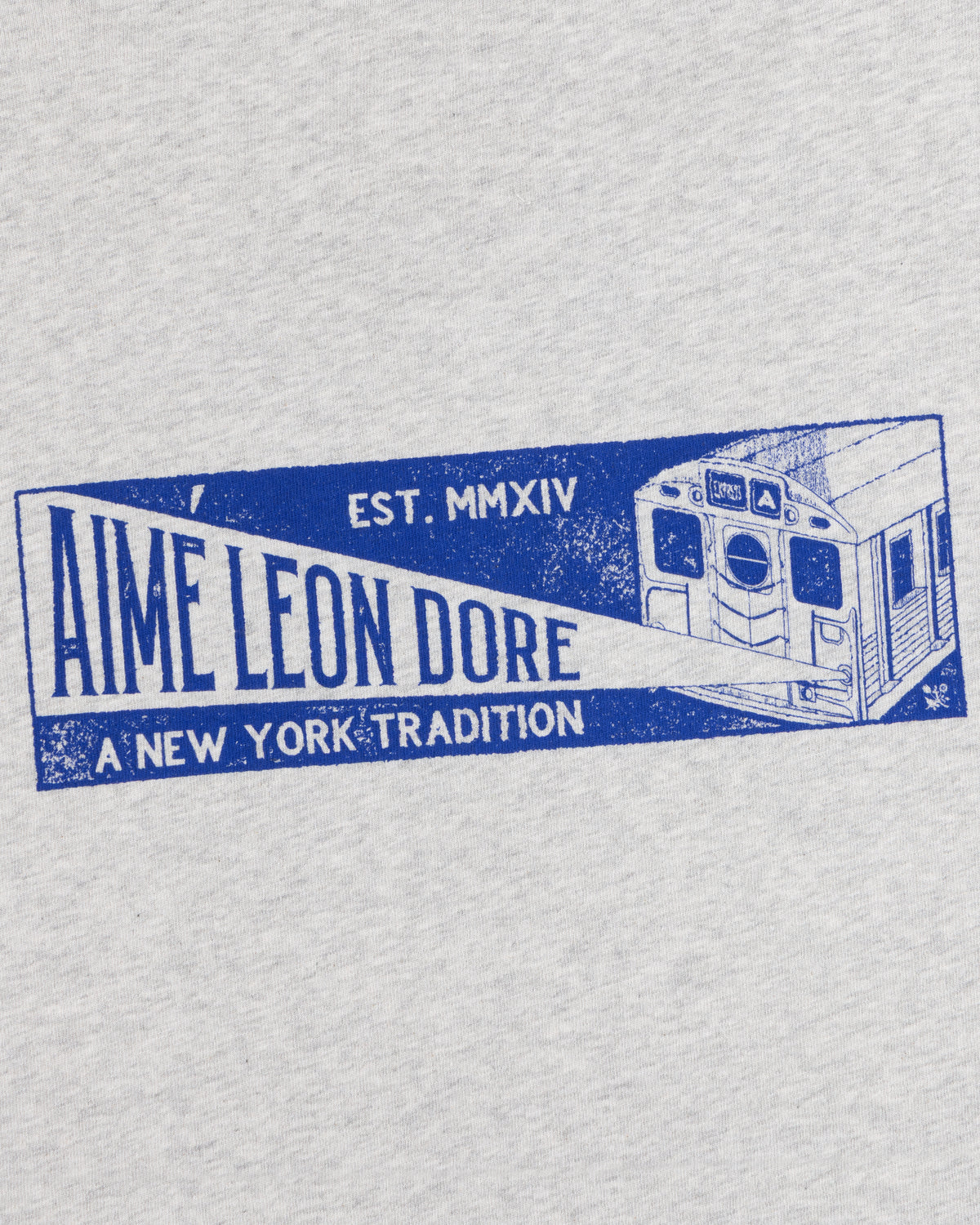 Light gray Aimé Transit Tee with a blue subway car graphic and text reading Aime Leon Dore, Est. MMXIV, A New York Tradition.